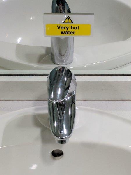 scotland hot water sign in a sink